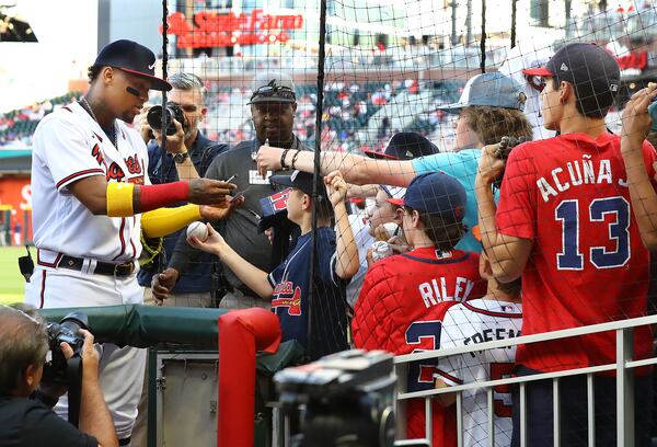 Braves outfielder Ronald Acuna signs autographs for young fans on Thursday, April 28, 2022, in Atlanta.    “Curtis Compton / Curtis.Compton@ajc.com”