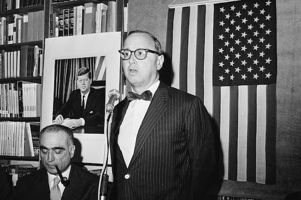 FILE - Arthur Schlesinger Jr., Harvard University historian and President John F. Kennedy's former personal assistant, holds a brief lecture as his book "A Thousand Days: John F. Kennedy in the White House" was presented to Italian public on Jan. 24, 1966 in Rome. Sitting at left is Italian journalist and author Luigi Barzini Jr. who introduced Schlesinger to the audience. (AP Photo/Gianni Foggia, File)