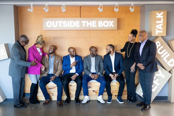 From left, H. Jerome Russell Jr.; Mori Russell; H.J. “Russ” Russell III; Emanuel “Manny” Major; Zane Major; Benjamin Russell; Lovette Twyman Russell; and Michael B. Russell Sr. pose for a portrait at the Russell Innovation Center for Entrepreneurs in Atlanta on Jan. 22. Arvin Temkar/AJC