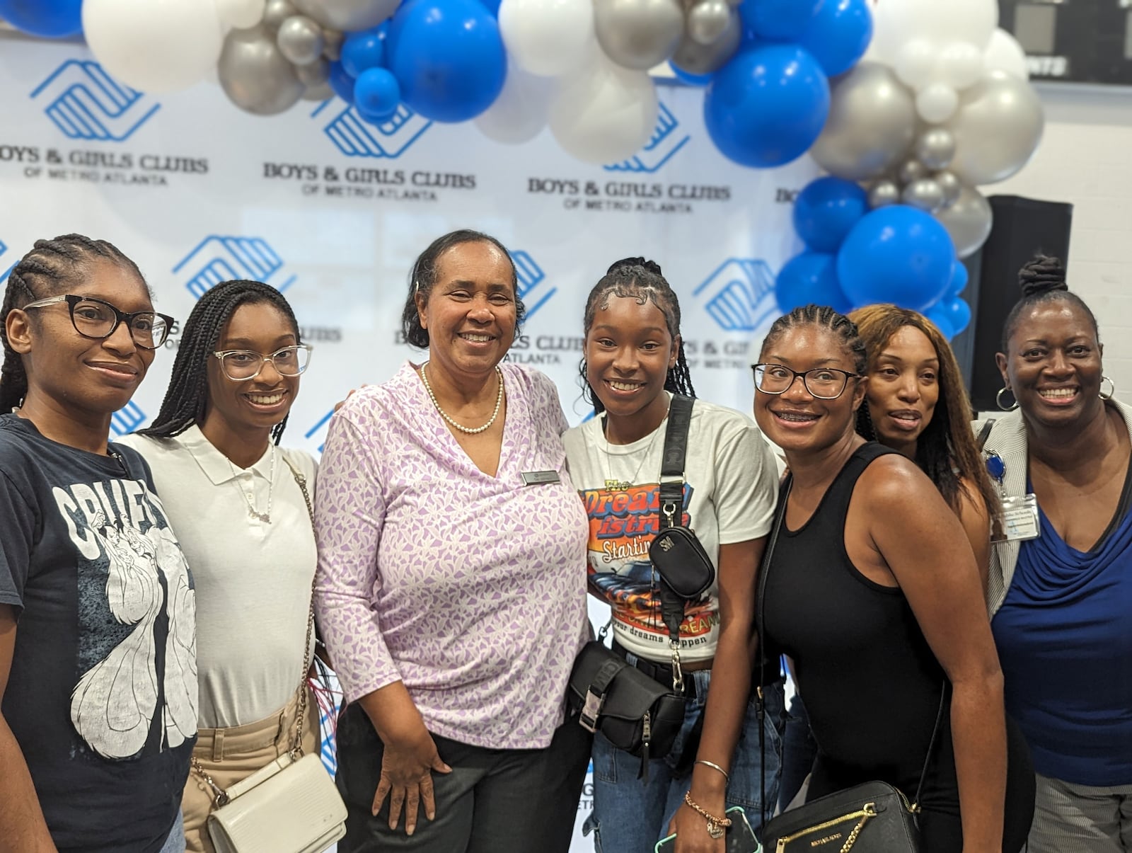 Gail Johnson is surrounded by alumnae of the Warren Boys & Girls Club at a surprise celebration on Aug. 30, 2023, marking her 45th year with the organization. To the far right is Atlanta Public Schools interim Superintendent Danielle Battle, who sent some of her family members to the club. (Courtesy of Boys and Girls Clubs of Metro Atlanta)