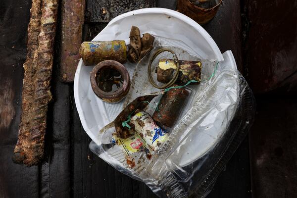 Batteries, hair ties and other trash collected after a dive to clean up the waters off the coast of Hon Mot Island, on Feb. 7, 2025, in Nha Trang, Vietnam. (AP Photo/Yannick Peterhans)