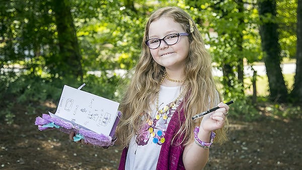 Alaya Horne poses for a photo with her diary in her Johns Creek neighborhood. (Photo: ALYSSA POINTER / ALYSSA.POINTER@AJC.COM}