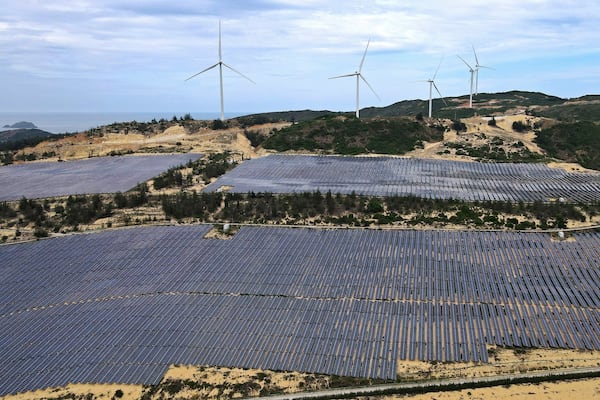 FILE - A solar farm operates near wind turbines in Quy Non, Vietnam on June 11, 2023. (AP Photo/Minh Hoang, File)