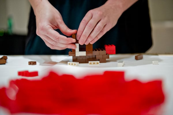 Kate Lawter builds a Rudolph the Red Nosed Reindeer sculpture using LEGOs during the LEGOLAND Discovery Center Atlanta's Brick Factor Competition at the Mandarin Oriental building in Atlanta on Sunday, November 23, 2014. Nine competitors were given an hour to build a sculpture with the theme of iconic holiday movies. Judges then crowned the victor with the title of Master LEGO Builder. There are seven Master Builders in the United States. JONATHAN PHILLIPS / SPECIAL