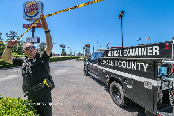 A Burger King in DeKalb County was roped off Monday morning after a fight led to a deadly shooting. JOHN SPINK / JSPINK@AJC.COM