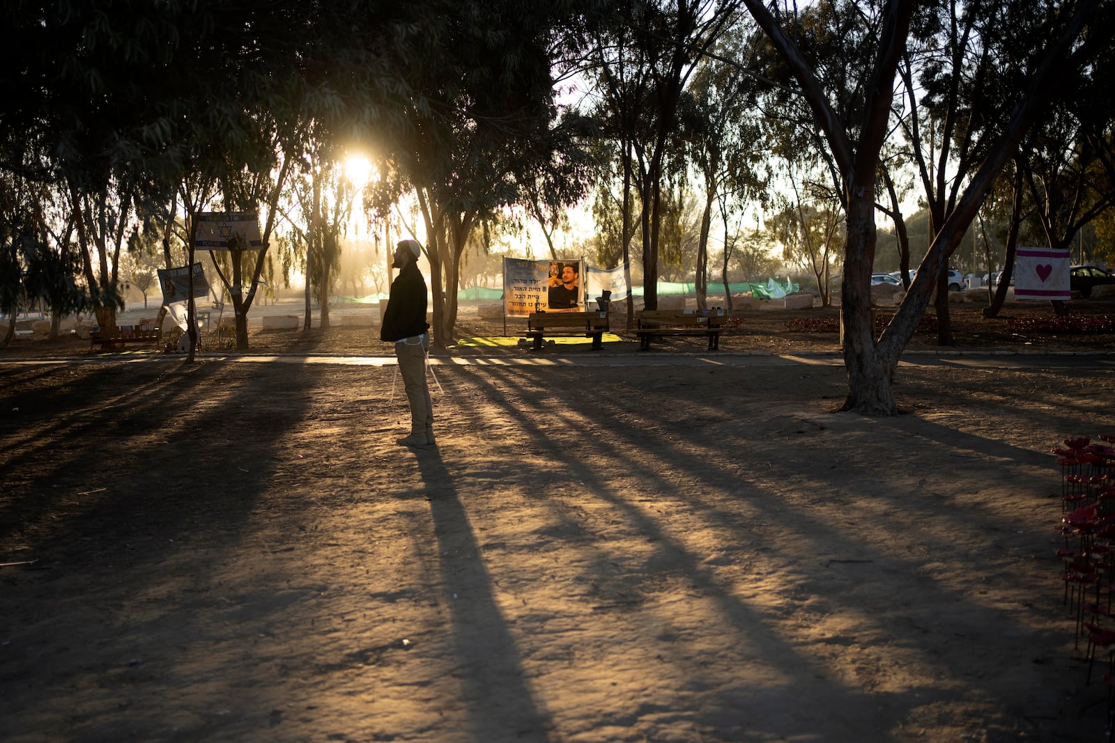 A man prays at the site of the Nova music festival, where hundreds of revelers were killed or kidnapped by Hamas, on the Jewish holiday of Simchat Torah, marking one year in the Hebrew calendar since the attack, near Kibbutz Re'im, southern Israel near the Gaza Strip, Thursday, Oct. 24, 2024. (AP Photo/Maya Alleruzzo)