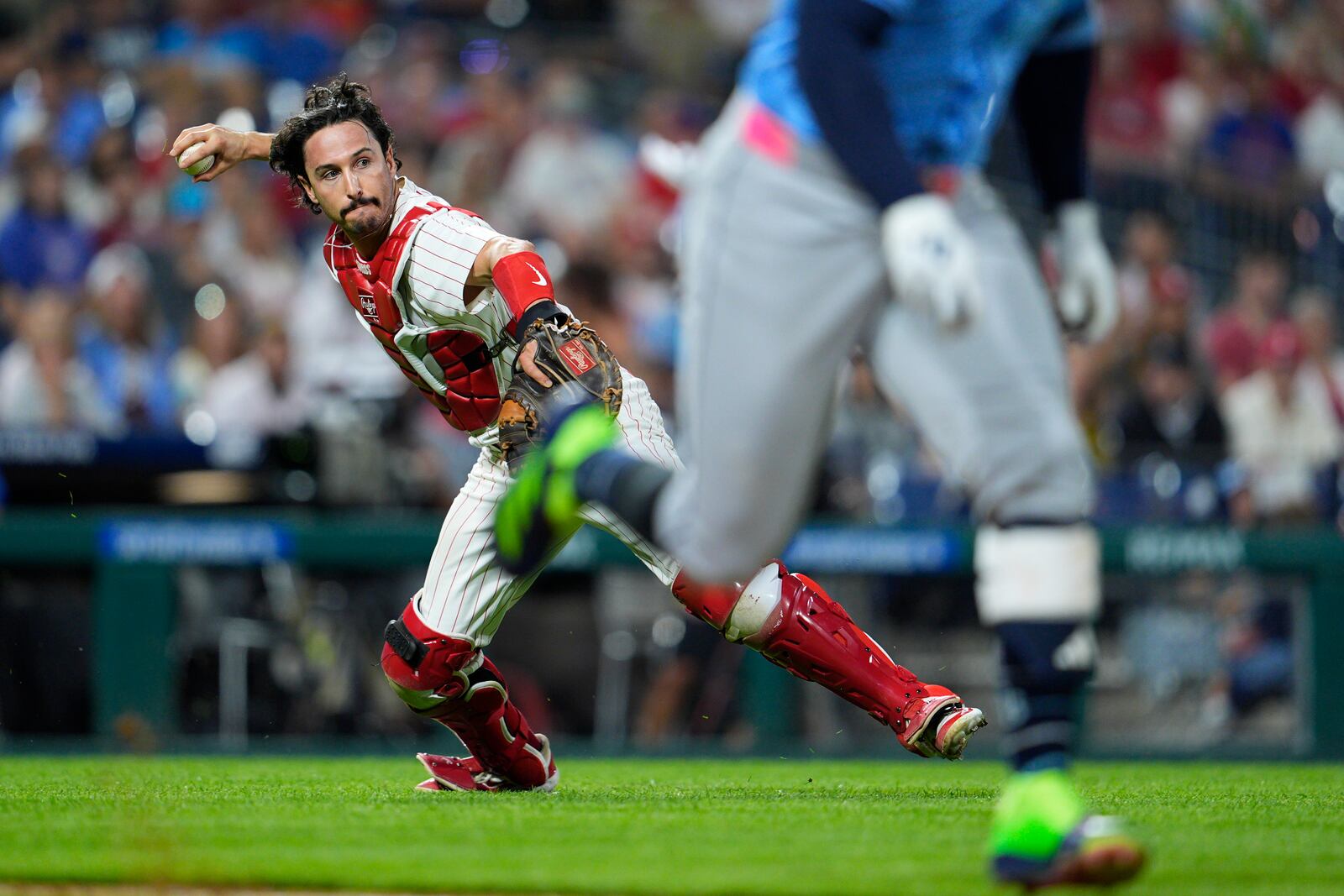 Philadelphia Phillies' Garrett Stubbs, left, throws to first for an out on a ball hit by Tampa Bay Rays' Yandy Díaz during the sixth inning of a baseball game, Tuesday, Sept. 10, 2024, in Philadelphia. (AP Photo/Derik Hamilton)