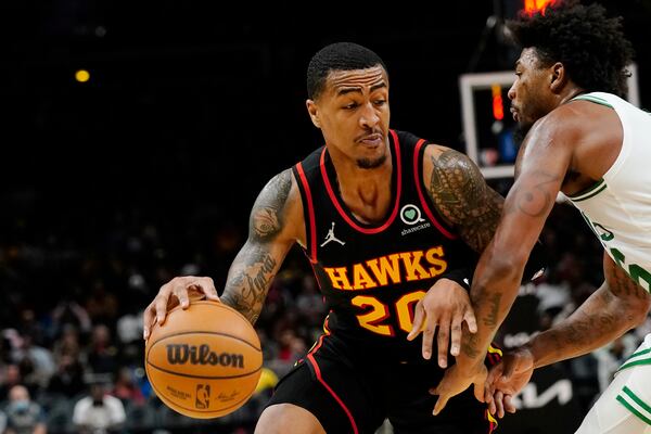 Atlanta Hawks forward John Collins (20) drives against Boston Celtics guard Marcus Smart (36) in the second half of an NBA basketball game Wednesday, Nov. 17, 2021, in Atlanta. (AP Photo/John Bazemore)