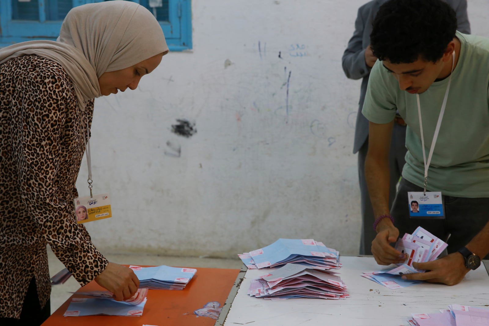 Election officials count the votes after the presidential elections in the capital Tunis, Tunisia, Sunday, Oct. 6, 2024. (AP Photo/Anis Mili)