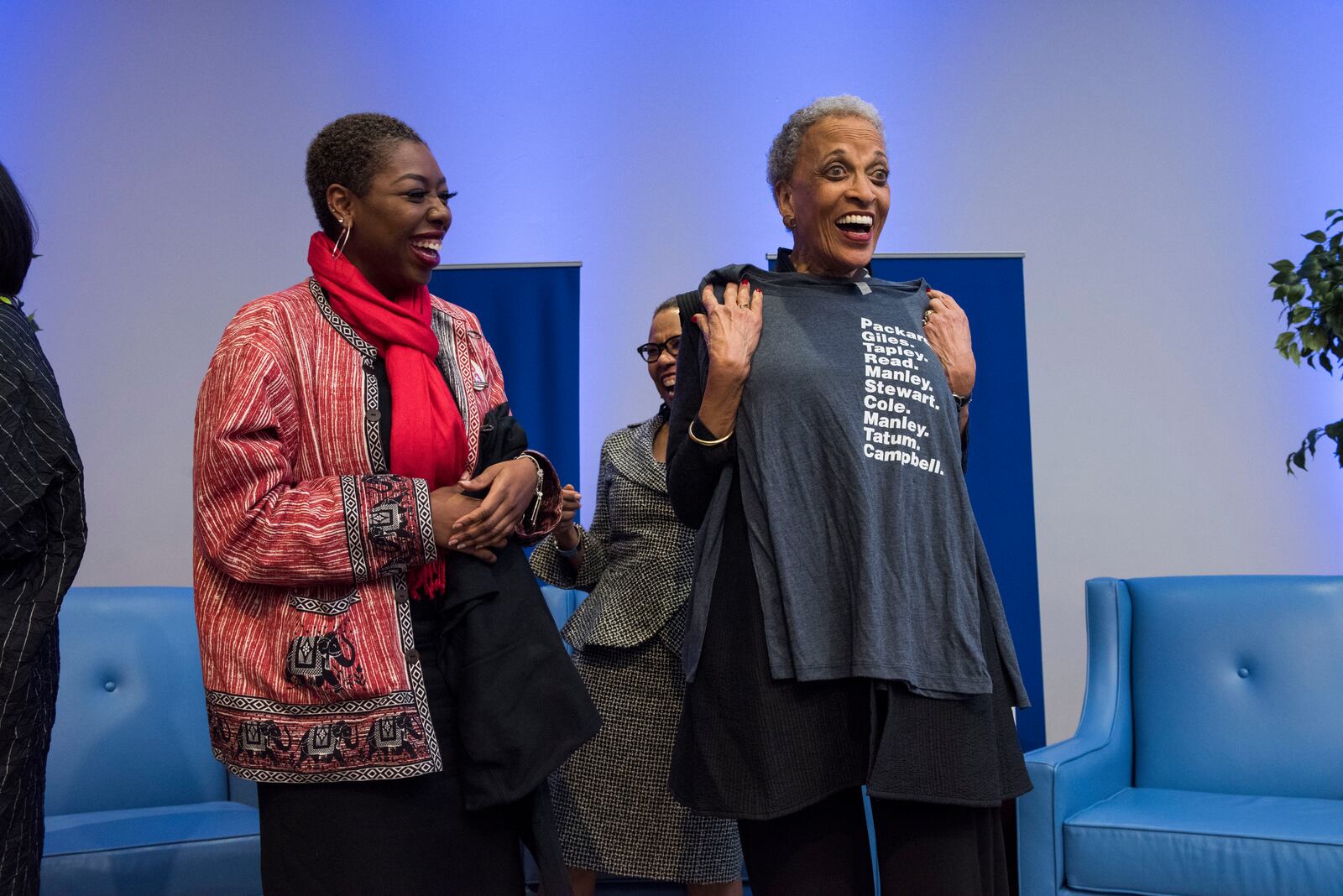 Johnnetta Betsch Cole (right), holding up a t-shirt with the names of all of Spelman''s former  Presidents from Sophia B. Packard to Mary Schmidt Campbell. Cole was the school's first Black women president after a century of leadership by white women and Black men. Dr. Helene Gayle is the current president. Julie Yarbrough Photography