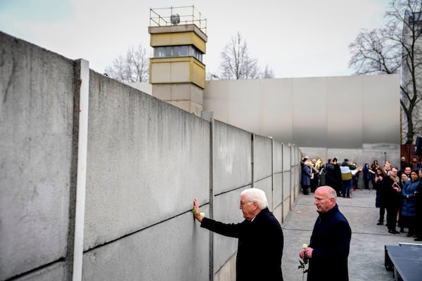 German President Frank-Walter Steinmeier, left, attends a flower laying ceremony on occasion of the 35th wall anniversary at the grounds of the Berlin Wall Memorial, Berlin, Germany, Saturday, Nov.9, 2024. (AP Photo/Ebrahim Noroozi)