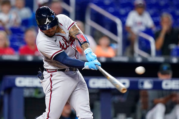 Atlanta Braves' Chadwick Tromp hits a single scoring Michael Harris II during the eighth inning of the first game of a baseball doubleheader against the Miami Marlins, Saturday, Aug. 13, 2022, in Miami. (AP Photo/Wilfredo Lee)