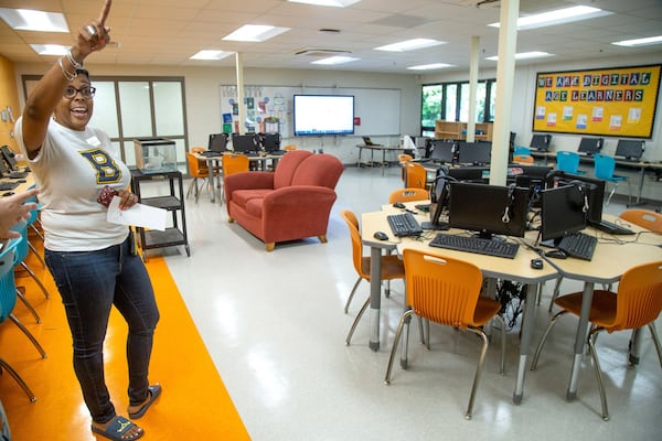 Beecher Hills Elementary school principal Crystal Jones (L) talks to families in the schools’ new computer lab at the first open house after the schools’ extensive renovation Friday, August 9, 2019. STEVE SCHAEFER / SPECIAL TO THE AJC