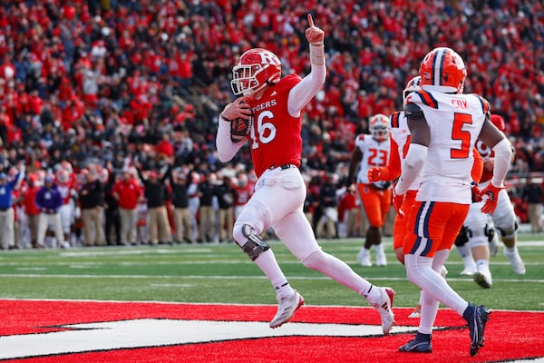 Rutgers quarterback Athan Kaliakmanis (16) gestures after running for a touchdown against the Illinois during the first half of an NCAA college football game Saturday, Nov. 23, 2024, in Piscataway, N.J. (AP Photo/Rich Schultz)