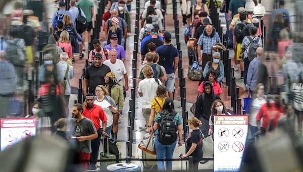 July 5, 2022 Hartsfield-Jackson International Airport: Airline travelers made their way through Hartsfield-Jackson International Airport in the security line on Tuesday, July 5, 2022 after managing through a busy Fourth of July weekend for air travel with storms and cancellations, airlines face the challenge of navigating through the rest of a busy summer. (John Spink / John.Spink@ajc.com)


