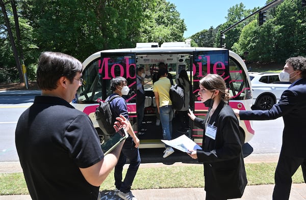 May 12, 2022 Peachtree Corners - Guests get on an autonomous shuttle for a test ride at Curiosity Lab shuttle stop in Peachtree Corners on Thursday, May 12, 2022. On Thursday May 12, top automakers, technology companies and carriers are coming together at the Curiosity Lab in Peachtree Corners and Applied Information in Alpharetta for live demos as part of the 5G Automotive Association (5GAA) conference. (Hyosub Shin / Hyosub.Shin@ajc.com)