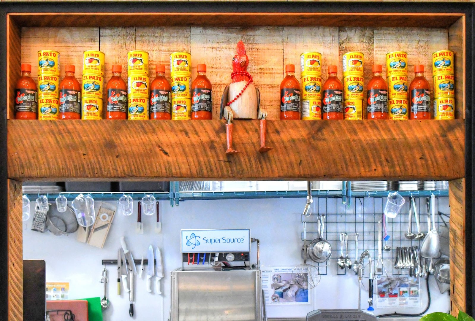 Athentic canned goods, sauces and artwork frame one of the food preparation areas. CONTRIBUTED BY CHRIS HUNT PHOTOGRAPHY.