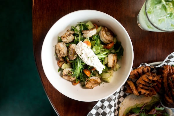 Black Sheep Tavern and Oyster Room Cucumber and Tomato salad with burrata, green onion, red wine vinaigrette, and added shrimp. Photo credit- Mia Yakel.