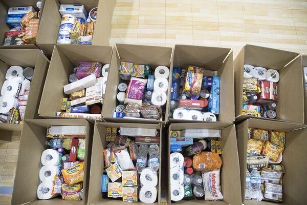 Boxes of food and toiletry items are ready for distribution during an Atlanta Community Food Bank and Fulton County Schools collaborative distribution at Elizabeth Baptist Church in Atlanta. ALYSSA POINTER / ALYSSA.POINTER@AJC.COM