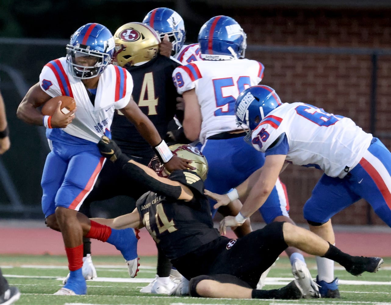 Sept. 24, 2021 - Johns Creek, Ga: Riverwood quarterback Avery Smith (14) is tackled by Johns Creek defensive lineman Andrew Guth (44) during the first half at Johns Creek high school Friday, September 24, 2021 in Johns Creek, Ga.. JASON GETZ FOR THE ATLANTA JOURNAL-CONSTITUTION