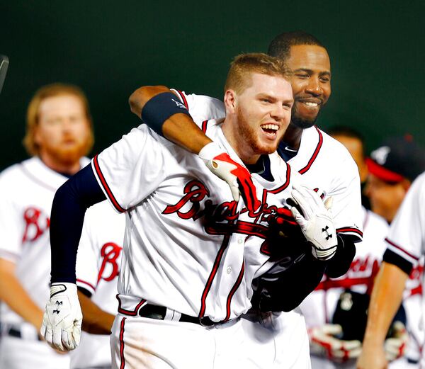 Braves first baseman Freddie Freeman, left,  gets hugged by teammate Jason Heyward after driving in the winning run against the San Francisco Giants Monday, Aug. 15,  2011 in Atlanta.  Atlanta won 5-4. (AP Photo/John Bazemore)