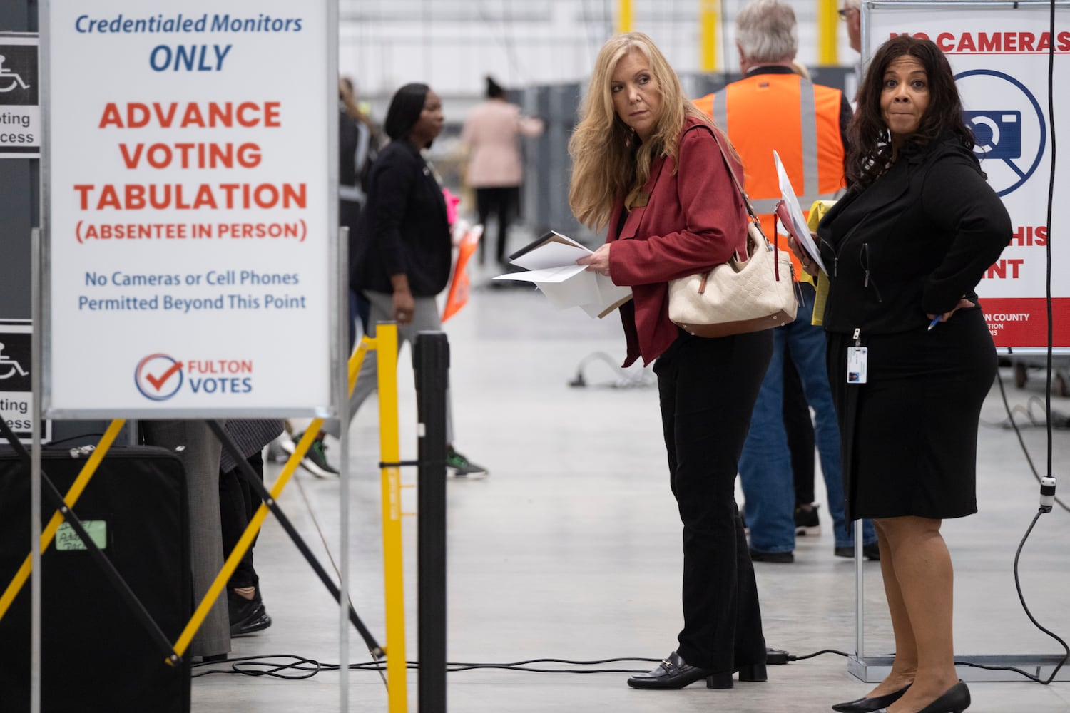 The Fulton County Registration and Elections Board member Julie Adams, left, and chair Sherri Allen monitor the start of advance voting tabulations at the Fulton County election hub in Fairburn on Tuesday, Nov. 5, 2024.   Ben Gray for the Atlanta Journal-Constitution