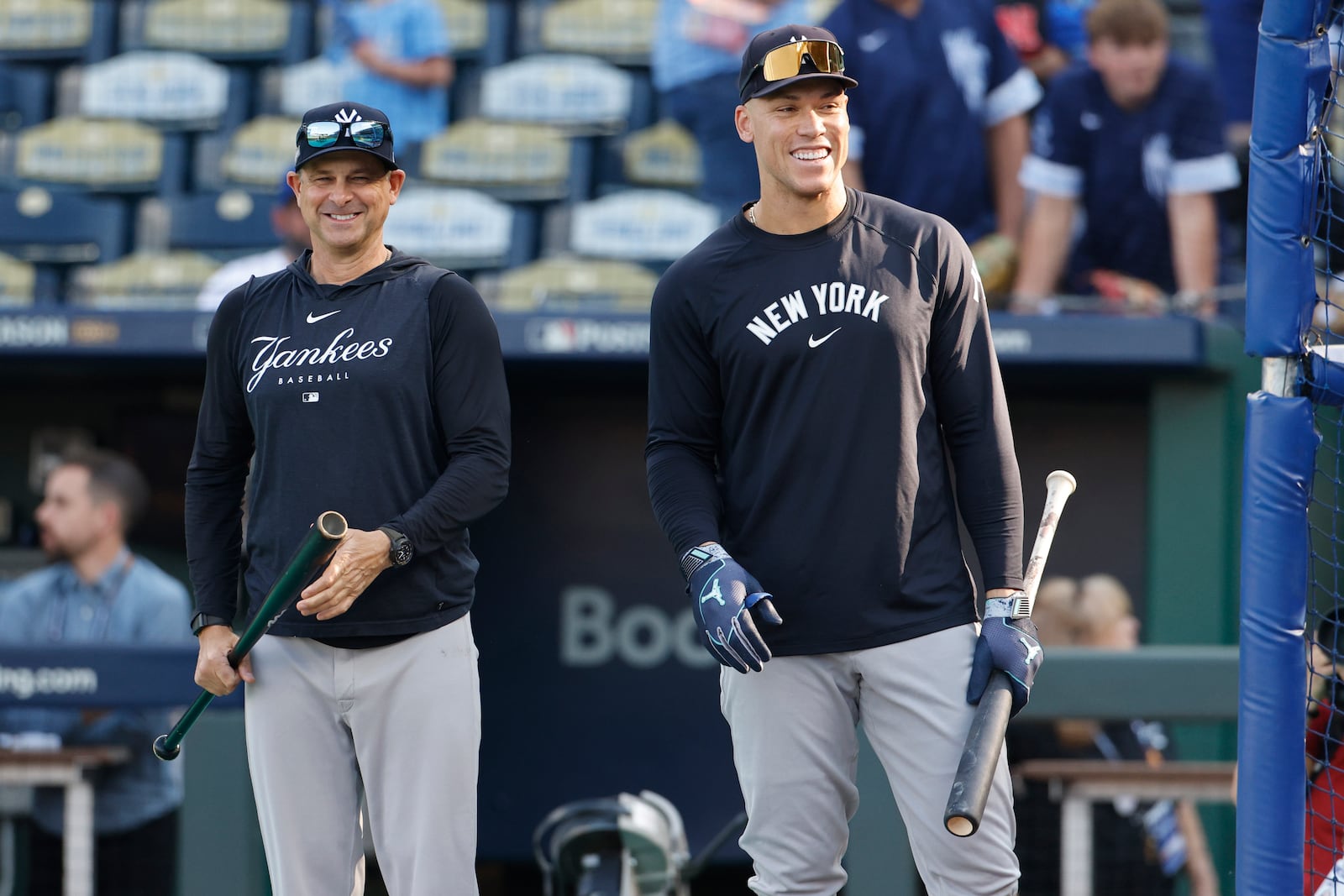 New York Yankees' Aaron Judge, right, smiles while taking batting practice as manager Aaron Boone looks on before the start of Game 3 of an American League Division baseball playoff series against the Kansas City Royals Wednesday, Oct. 9, 2024, in Kansas City, Mo. (AP Photo/Colin Braley)