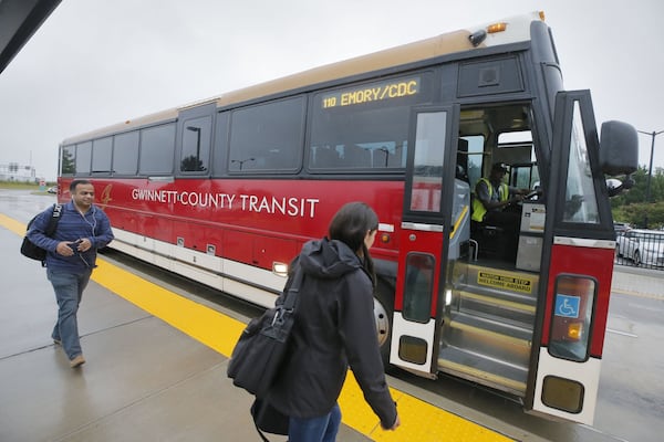 8/2/18 - Lawrenceville - Commuters board Gwinnett County Transit express buses departing for downtown Atlanta at the Express Bus Park and Ride lot at Sugarloaf Mills in Lawrenceville. BOB ANDRES /BANDRES@AJC.COM