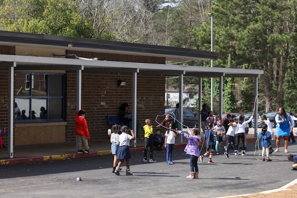 Elementary school students play during their recess in a parking lot at RISE Schools, on Wednesday, Feb. 22, 2023, in East Point, Ga. The RISE Grammar and Prep schools are in jeopardy of being closed by Fulton County Schools. The students play in the parking lot because their playground is under construction. Jason Getz / Jason.Getz@ajc.com)