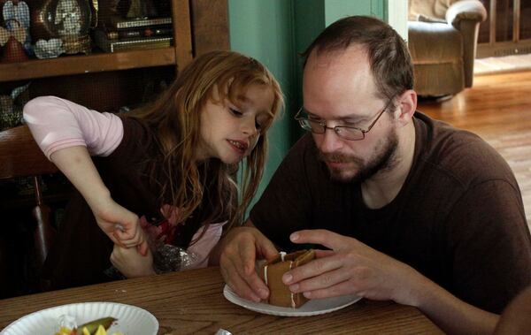 Matt Lindsey and SarahBeth working on a gingerbread house. 