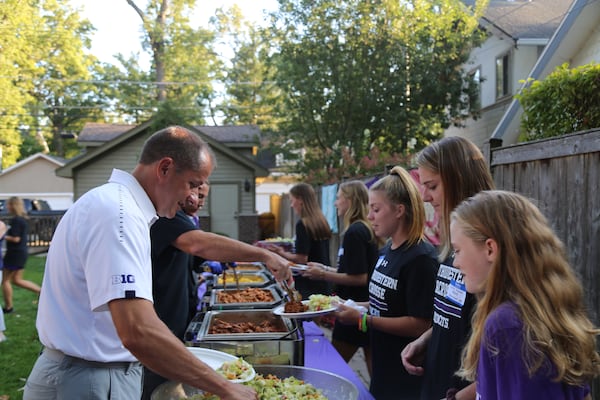 Jim Phillips serves dinner to the Northwestern lacrosse team at his family's home in Evanston, Ill., in September 2019 in his capacity as the school's athletic director. In his 13 years in that position, Phillips annually invited all of Northwestern's varsity teams to his home. He was named ACC commissioner in December 2020. (Northwestern Athletics)