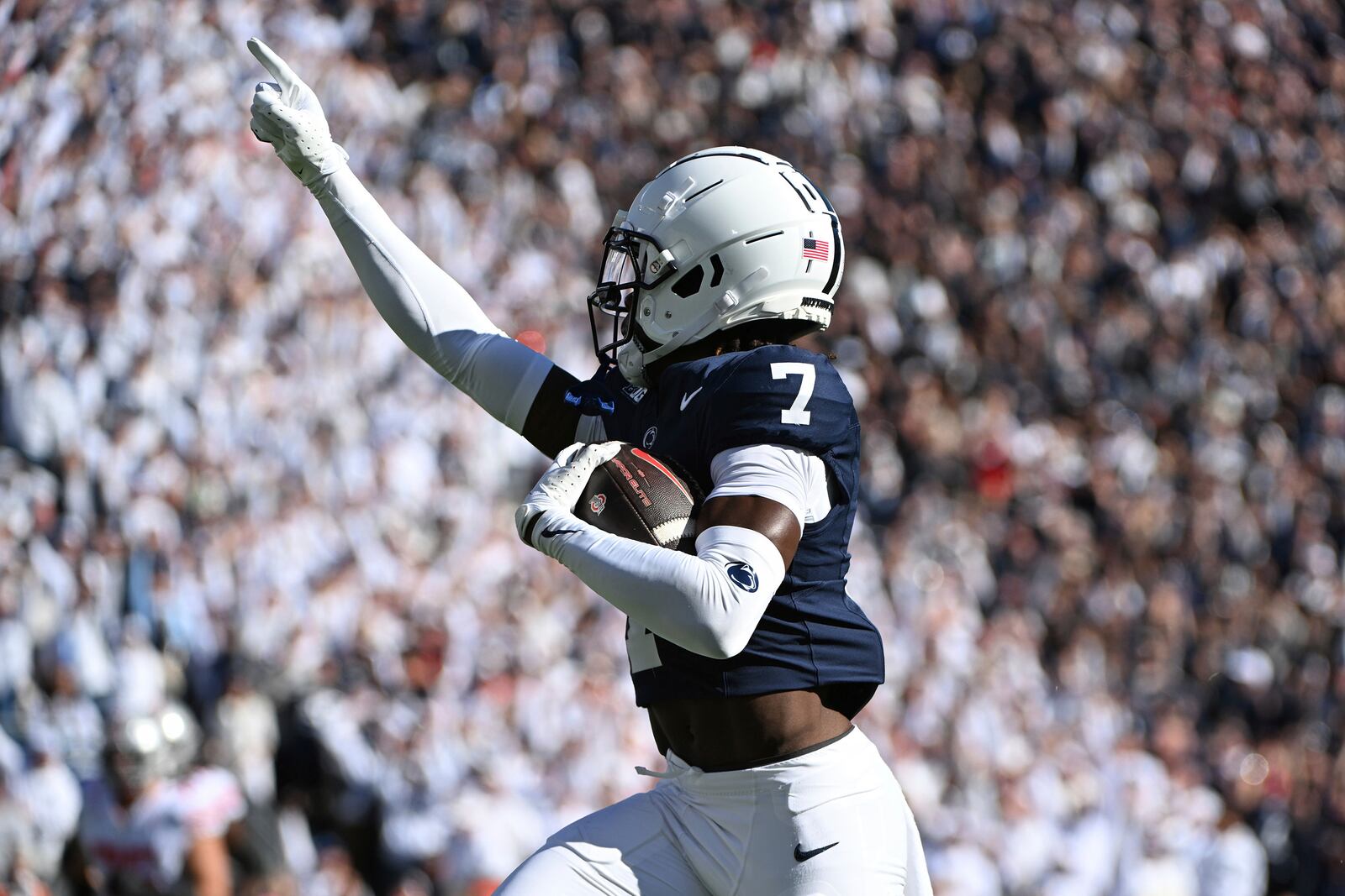 Penn State cornerback Zion Tracy (7) returns an interception for a touchdown against Ohio State during the first quarter of an NCAA college football game, Saturday, Nov. 2, 2024, in State College, Pa. (AP Photo/Barry Reeger)