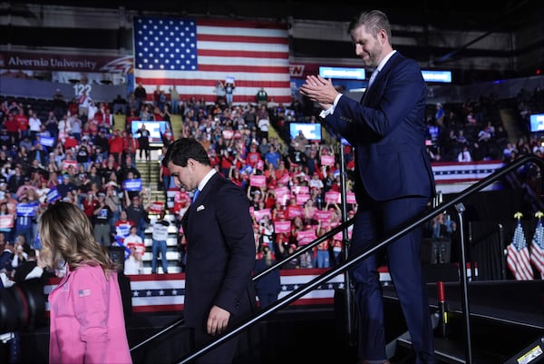 From left, Lara Trump, Michael Boulos, and Eric Trump leave the stage as Republican presidential nominee former President Donald Trump speaks during a campaign rally at Santander Arena, Monday, Nov. 4, 2024, in Reading, Pa. (AP Photo/Evan Vucci)