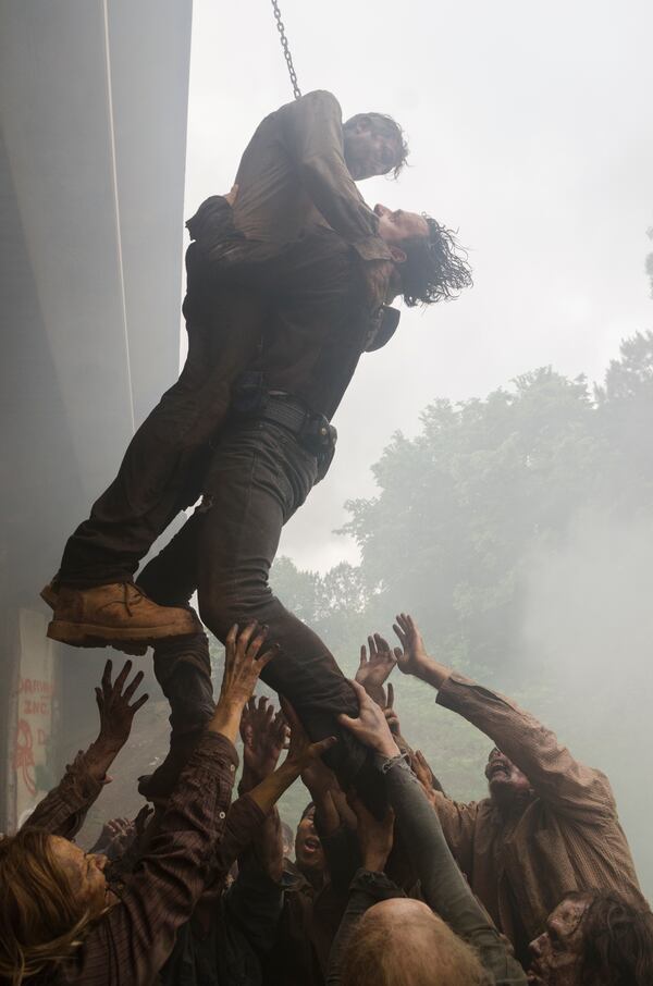 Rick Grimes uses a hanging walker to avoid bullets - The Walking Dead _ Season 7, Episode 1 - Photo Credit: Gene Page/AMC