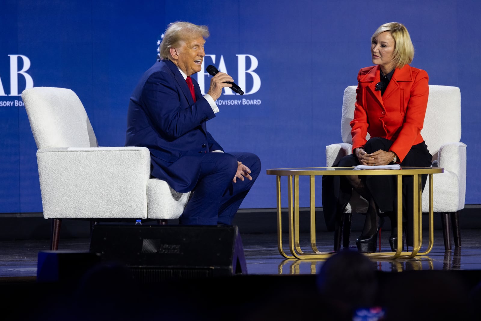 Former President Donald Trump answers question from Paula White-Cain at a summit in Powder Springs on Monday.