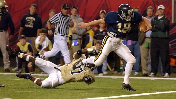 Marist quarterback Sean McVay (18), scores a touchdown while breaking the tackle by Thomas County Central's Brandon Burns during the Class AAAA finals Dec. 12, 2003, at the Georgia Dome.