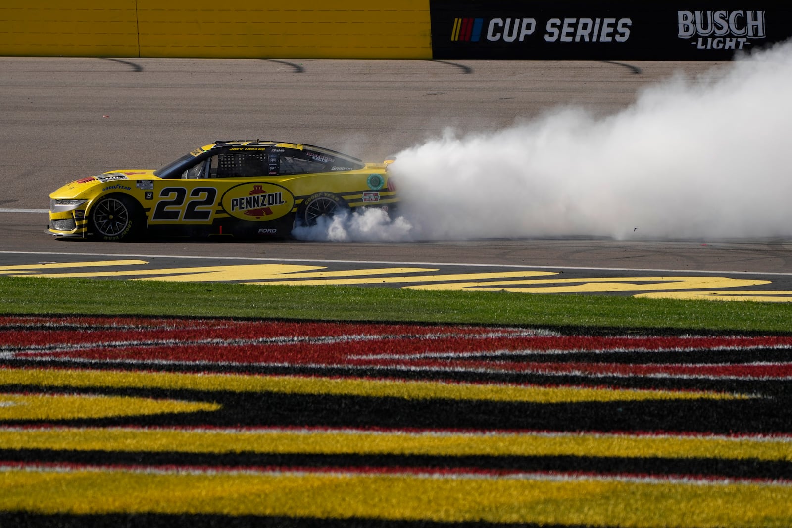 NASCAR Cup Series driver Joey Logano (22) does a burnout after winning a NASCAR Cup Series auto race Sunday, Oct. 20, 2024, in Las Vegas. (AP Photo/John Locher)