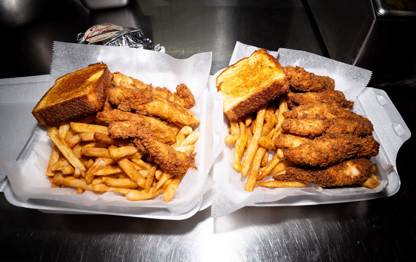 Two containers of chicken tenders, fries and Texas Toast are prepared in the kitchen at Jaybee's Tenders in Decatur, GA on Thursday, July 25, 2024. (Seeger Gray / AJC)