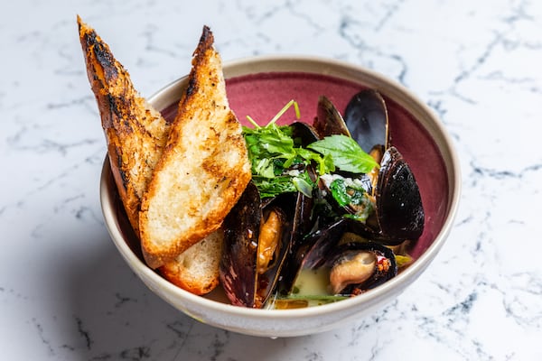 The mussels at Juniper Cafe are served with a rich lemongrass-coconut broth, with thin slivers of star fruit. Courtesy of Eric Sun