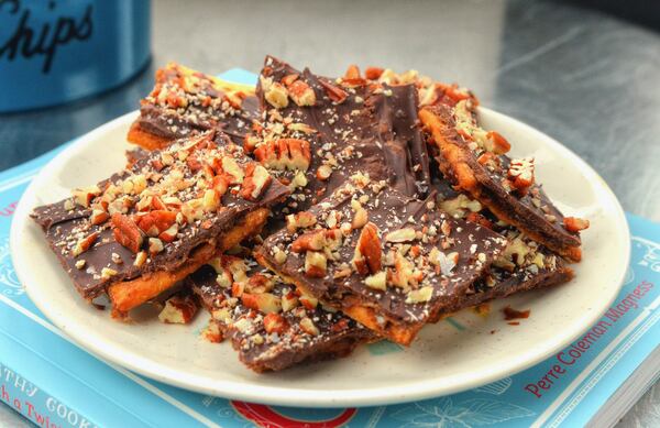 Sweet, savory and very addictive, Saltine Toffee can be made in a jiffy from everyday ingredients: crackers, brown sugar, butter, chocolate. This recipe, from Perre Coleman Magness’ “The Southern Sympathy Cookbook: Funeral Food with a Twist” (Countryman Press, $22.99), takes it up a notch by adding chopped pecans and flaky sea salt. STYLING BY WENDELL BROCK. CONTRIBUTED BY CHRIS HUNT