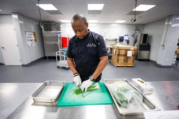 Executive Chef Chris Kelly, who spent 11 years cooking for Four Seasons resorts, prepares food at the Meals on Wheels Atlanta kitchen.
(Miguel Martinez / AJC)