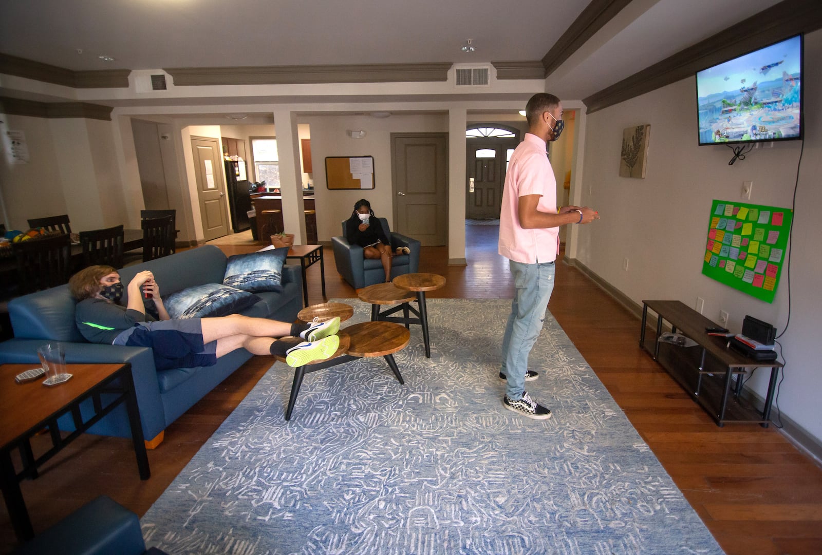 Raheem Forbes (R) plays a video game while hanging out with his roommates at the ASCEND living-learning village where they live Friday, November 13, 2020.   STEVE SCHAEFER / SPECIAL TO THE AJC 