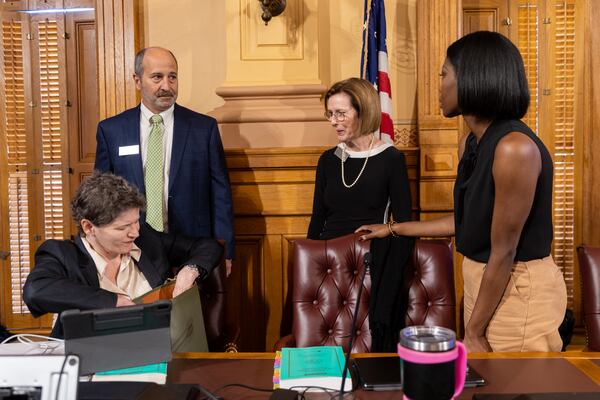 State Election Board member Sara Tindall Ghazal (seated) and Board Chair John Fervier have often voted in opposition to a trio of Republicans whom former President Donald Trump praised as “pit bulls” ― including Janice Johnston (center) and Janelle King ― on changes made to the state's election rules since midsummer. Arvin Temkar/AJC