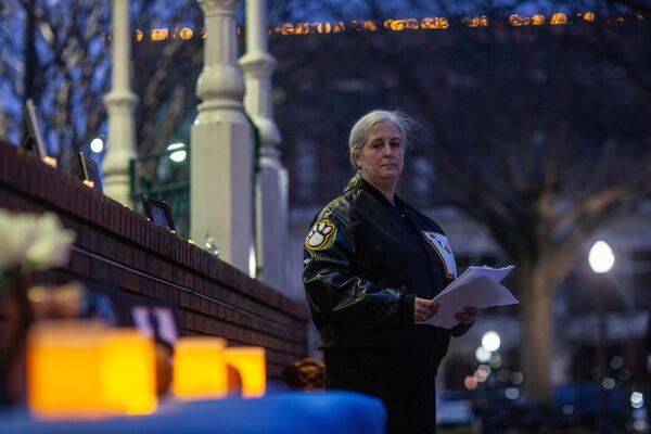 Amanda Planchard speaks Thursday night during a vigil for her brother, Chet Planchard, who was one of four people killed by Ronald Freeman 30 years ago.