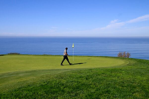 Phil Mickelson walks on the green on the fourth hole of the South Course at Torrey Pines during the first round of the Farmers Insurance Open golf tournament, Wednesday, Jan. 26, 2022, in San Diego. (AP Photo/Denis Poroy)