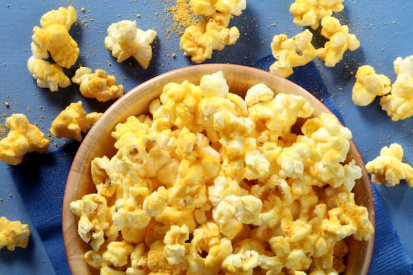 Cheesy popcorn from the store can never be as hot and fresh tasting as when you make it at home with cheese powder. (Michael Tercha/Chicago Tribune/TNS)