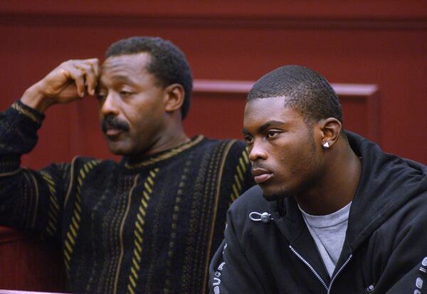 Falcons quarterback Michael Vick (right) in court in Clayton County on Jan. 18, 2002, where he took care of some outstanding citations issued in October. Accompanying Vick in court was former Falcons player Billy Johnson, coordinator of player programs for the team. RICH ADDICKS/AJC file