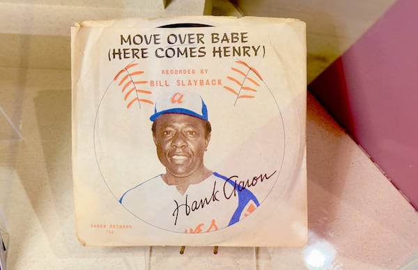 A copy of a vinyl 45 record featuring a novelty song released during Hank Aaron's pursuit of Babe Ruth's home run record is among the items on display through July at the Georgia Sports Hall of Fame in Macon. (Joe Kovac Jr. / AJC)