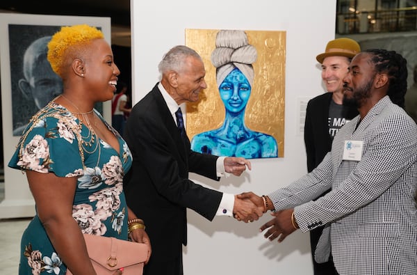 Dr. CT Vivian explores art inspired by faith by local Atlanta artist at an exhibition Beauty in Harmony curated by Ashley Woods, Carlton Mackey and Mindy Boggs (not pictured)