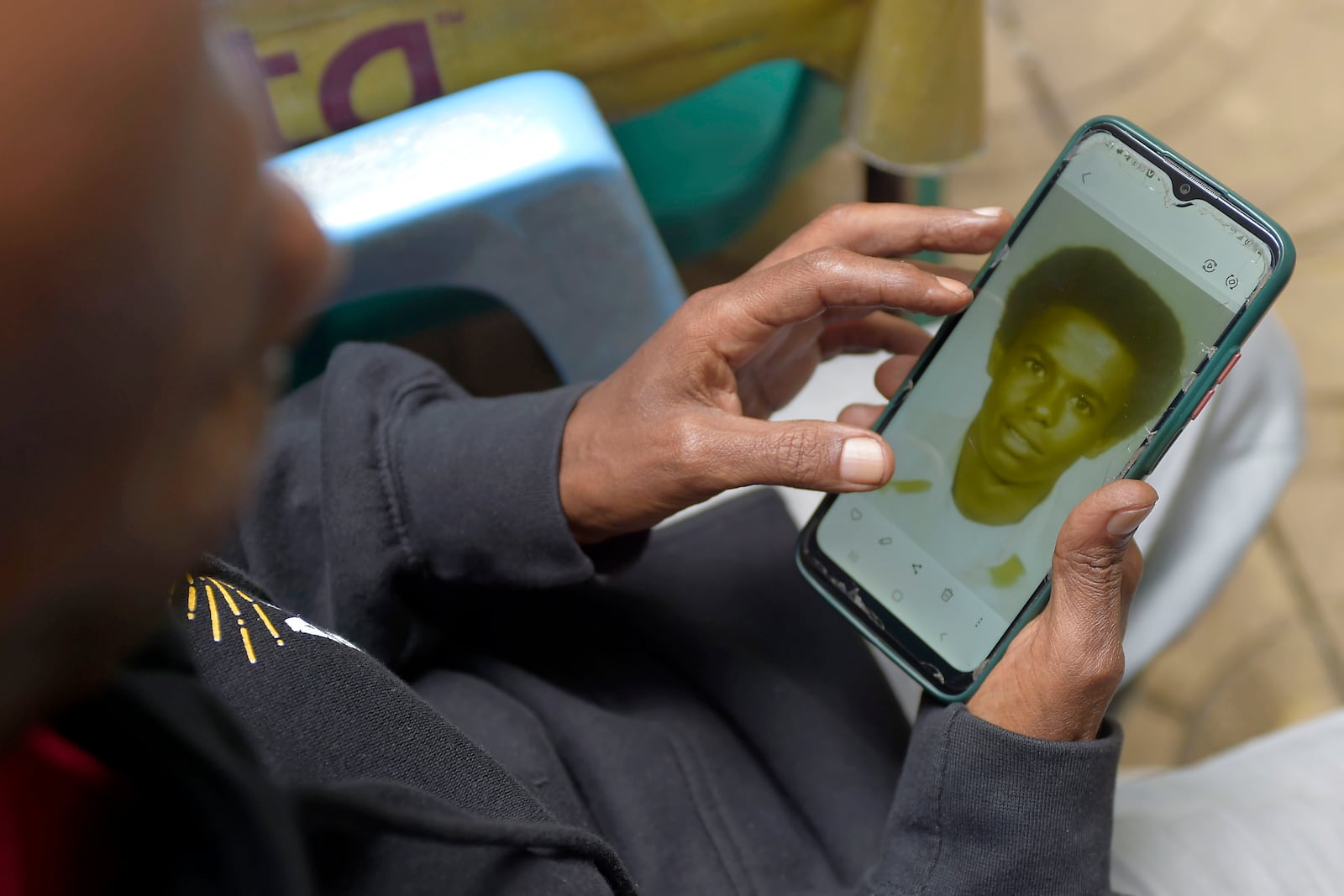 Mike Davis, 61, looks at a photo of him as a teenager, Friday, Aug. 23, 2024, in Addis Ababa, Ethiopia. Davis has five grandchildren he's never met. His youngest son, Adam, 26 now, recently moved into his first apartment, and thought how nice it would be to have his father there to see it. (AP Photo)